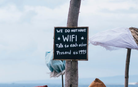 sign on beach that says we do not have wifi talk to each other pretend its 1995